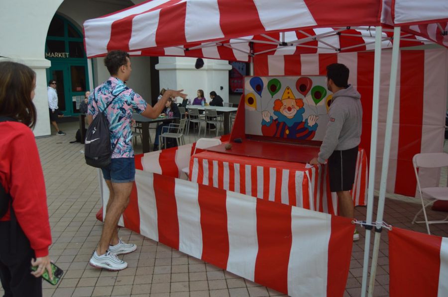 SDSU Student attempts carnival game at the Student Union. 