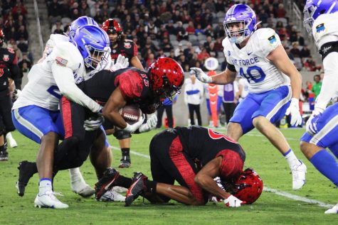 The Air Force defense tackles Aztec senior running back Jordan Byrd during a game that resulted in a 13-3 loss for the SDSU football team, on Nov 26, 2022.