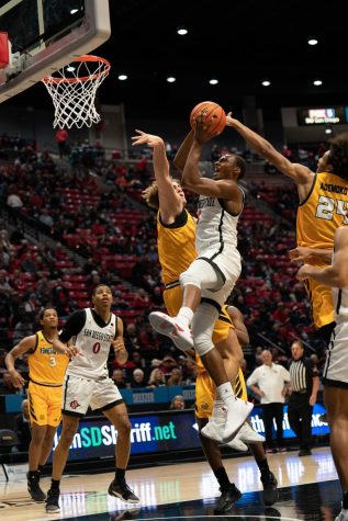 Junior Micah Parrish fights through contact for a layup against Kennesaw State on Dec. 12, 2022