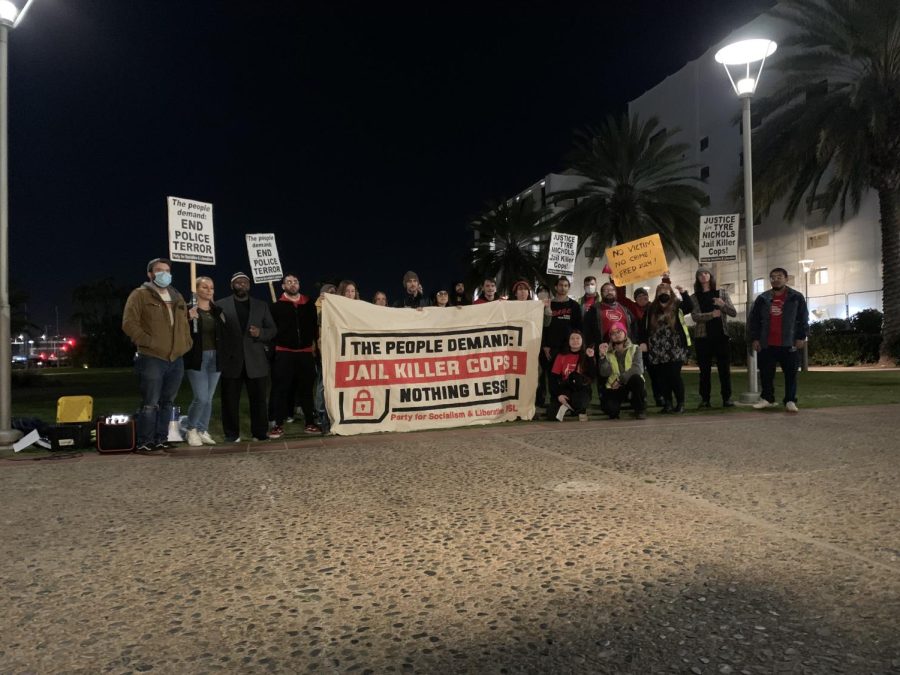Protesters hold signs demanding justice for Tyre Nichols at Waterfront Park on Jan. 27.