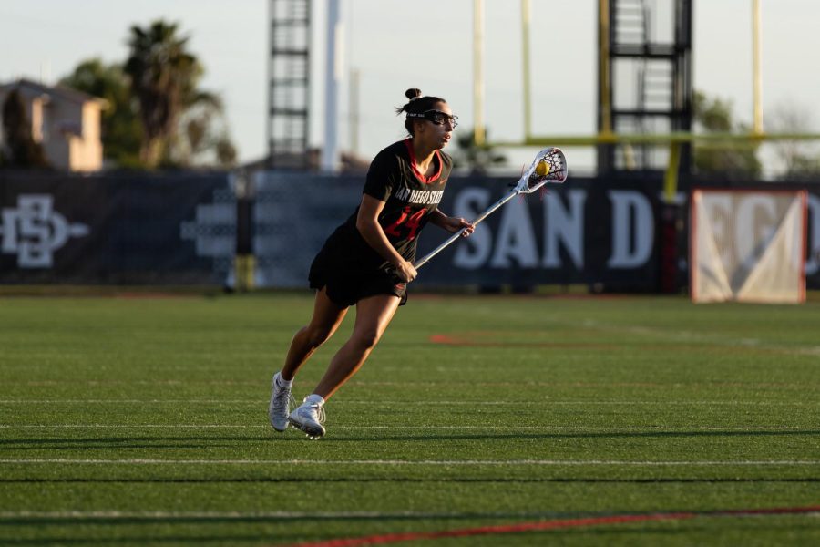 Senior attacker Deanna Balsama carrying the ball up field against Ohio State on Feb. 17, 2023.