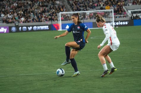 Alex Morgan protects the ball from her defender in a playoff game versus the Chicago Red Stars last season.