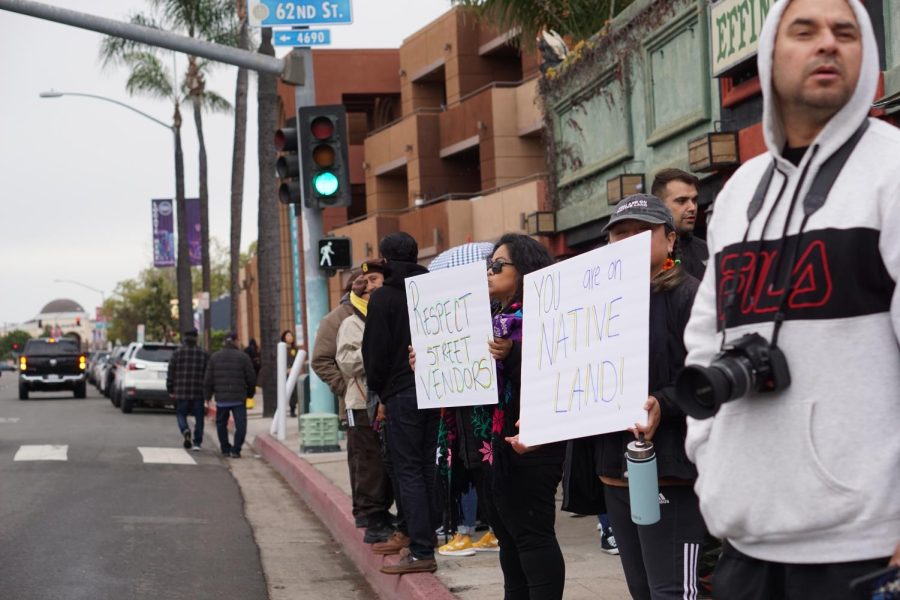 Community+members+hold+signs+in+solidarity+with+Andres+Arguelles-Alvarez%2C+a+street+vendor+who+was+recently+harassed+near+the+Viejas+Arena%2C+on+Feb.+19.