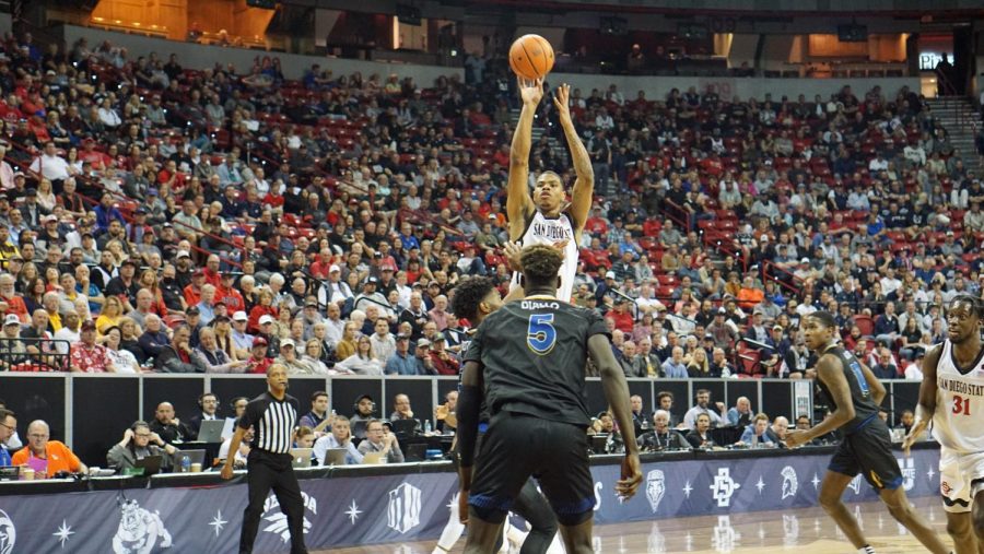 Senior forward Keshad Johnson shoots a jump shot over two San José State defenders on March 10. 
