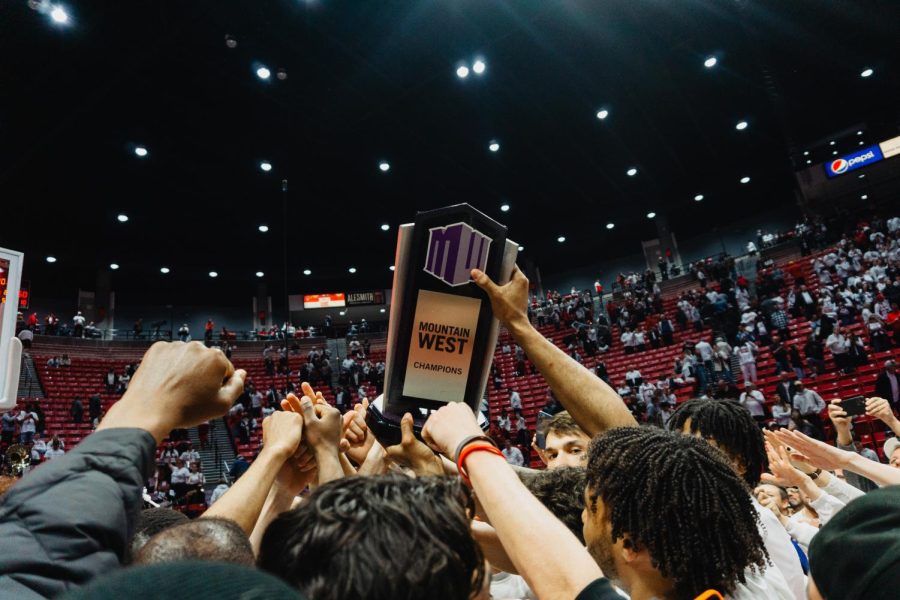 The Aztec mens basketball team hoists the 2022-23 Mountain West trophy following the win over Wyoming on March 4. 