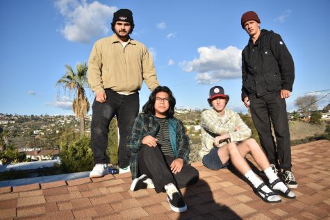 Andre Ghashghaee, Sebastian Sotero, Michael McGoven and Ian Kearns pose on a roof on December 13, 2022. 