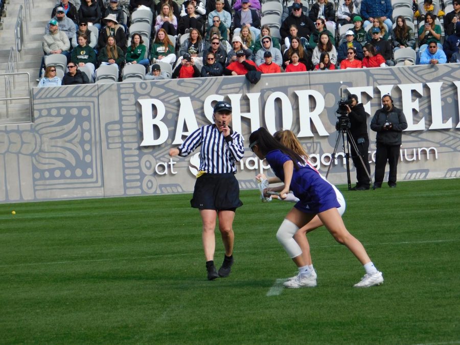 Senior midfielder Cailin Young and High Point graduate midfielder Emma Genovese get ready for the opening faceoff as the referee blows the whistle on Sunday, March 5.