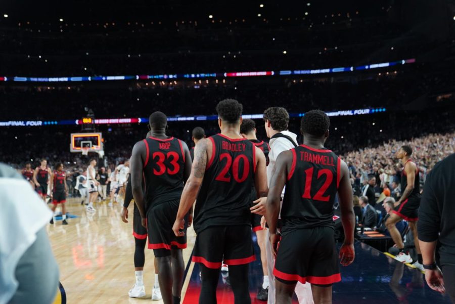 From left to right, seniors Aguek Arop, Matt Bradley and Darrion Trammell walk to shake hands with UConn players following the NCAA championship game on April 3.