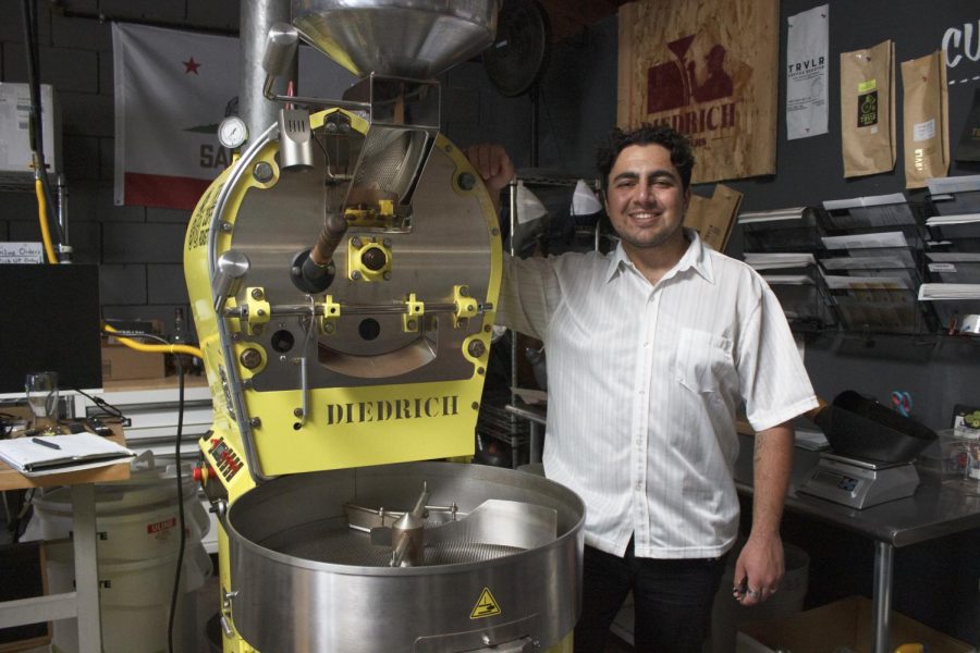 Elias Tchapadrian poses with the coffee roaster where he roasts in San Diego on Friday, Apr. 21.