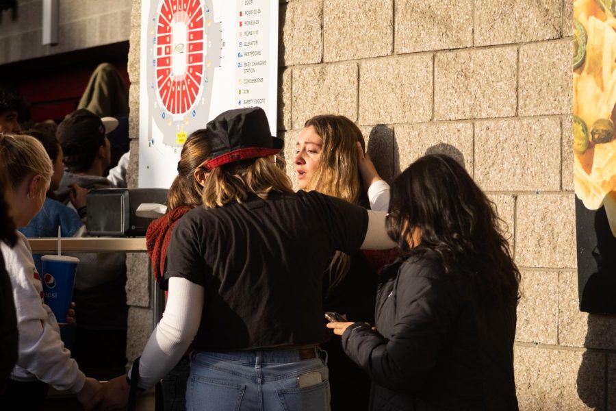 A student tries to catch her breath after escaping the rampaging crowd trying to get into the Viejas Arena on Monday, April 3 in San Diego, CA. Students were seen jumping the gates and opening the doors, letting hundreds of students flood the entrance despite warnings that the stadium was at max capacity.
