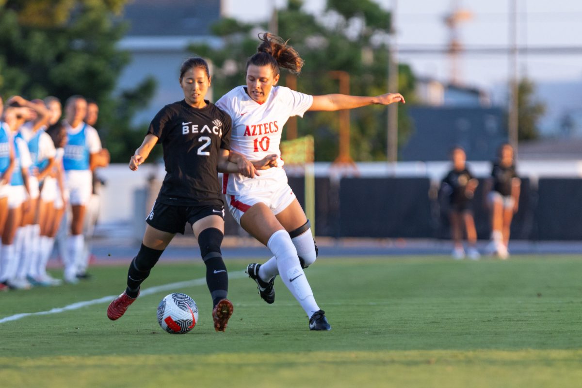 Aztec forward Kali Trevithick (10) collides with Long Beach States Kana Uchida (2) during a non-conference match at the SDSU Sports Deck on Aug. 27, 2023.