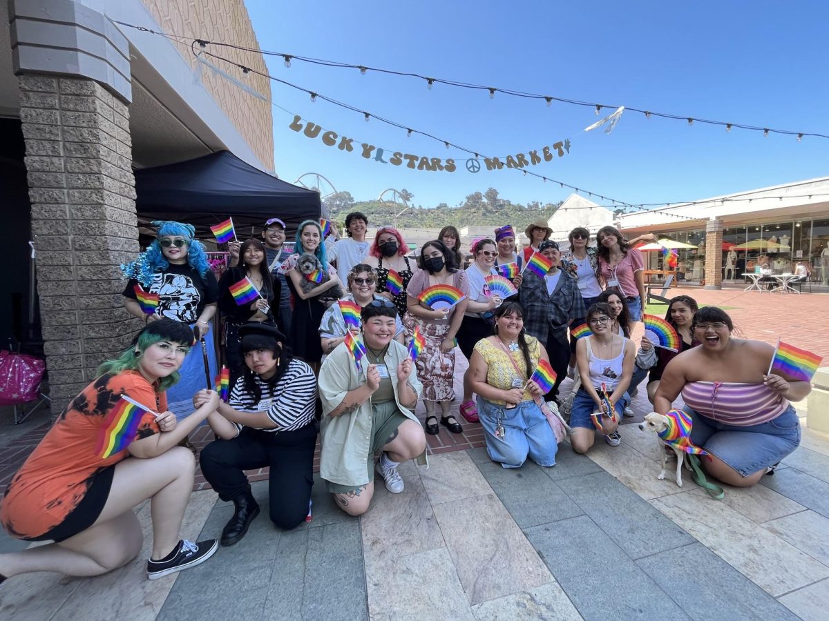 Kimberly Lee and vendors holding up pride flags to celebrate diversity and the beginning of the two-day market event on July 1, 2023.