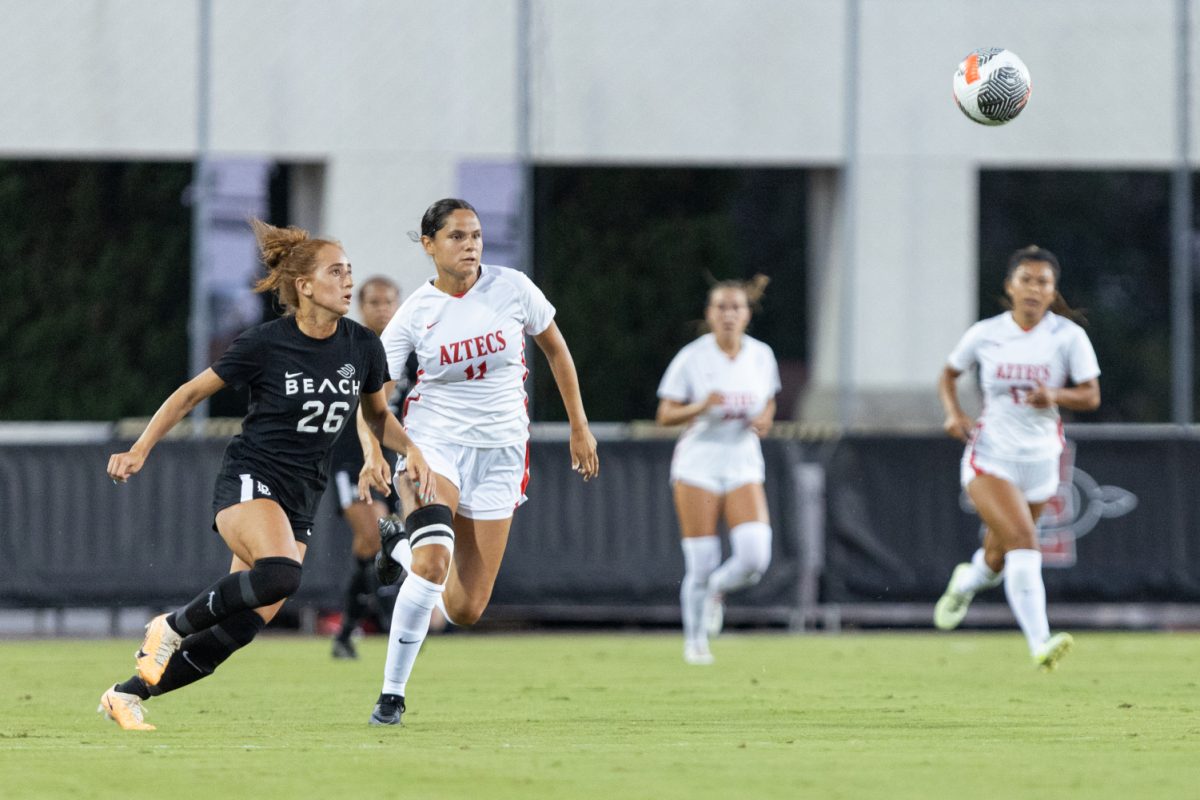 Denise Castro (11) and Brooklyn Antonucci (26) run towards the ball during a non-conference match at the SDSU Sports Deck on Aug. 27, 2023.