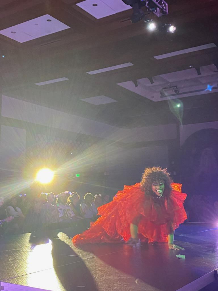 A performer lights up the stage at Dragstravaganza: Halftime.