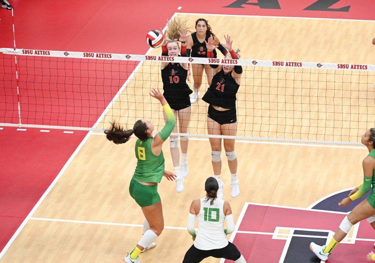 San Diego States Taylor Underwood (10) and Kat Cooper (21) rise up for a block during action earlier this season at Aztec Court at Peterson Gym. Underwood led the Aztecs with 16 kills against New Mexico on Saturday, Oct. 7, while Cooper missed the match due to an injury.