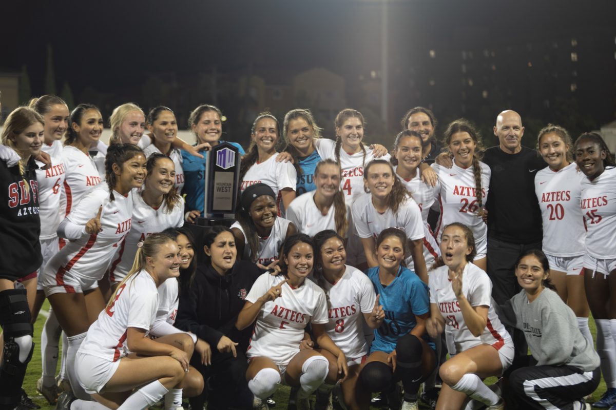 The San Diego State womens soccer team celebrates with the 2023 Mountain West regular season championship trophy on Thursday, Oct. 26 at the SDSU Sports Deck. The Aztecs beat New Mexico 2-0 to claim their sixth Mountain West regular season title in program history.