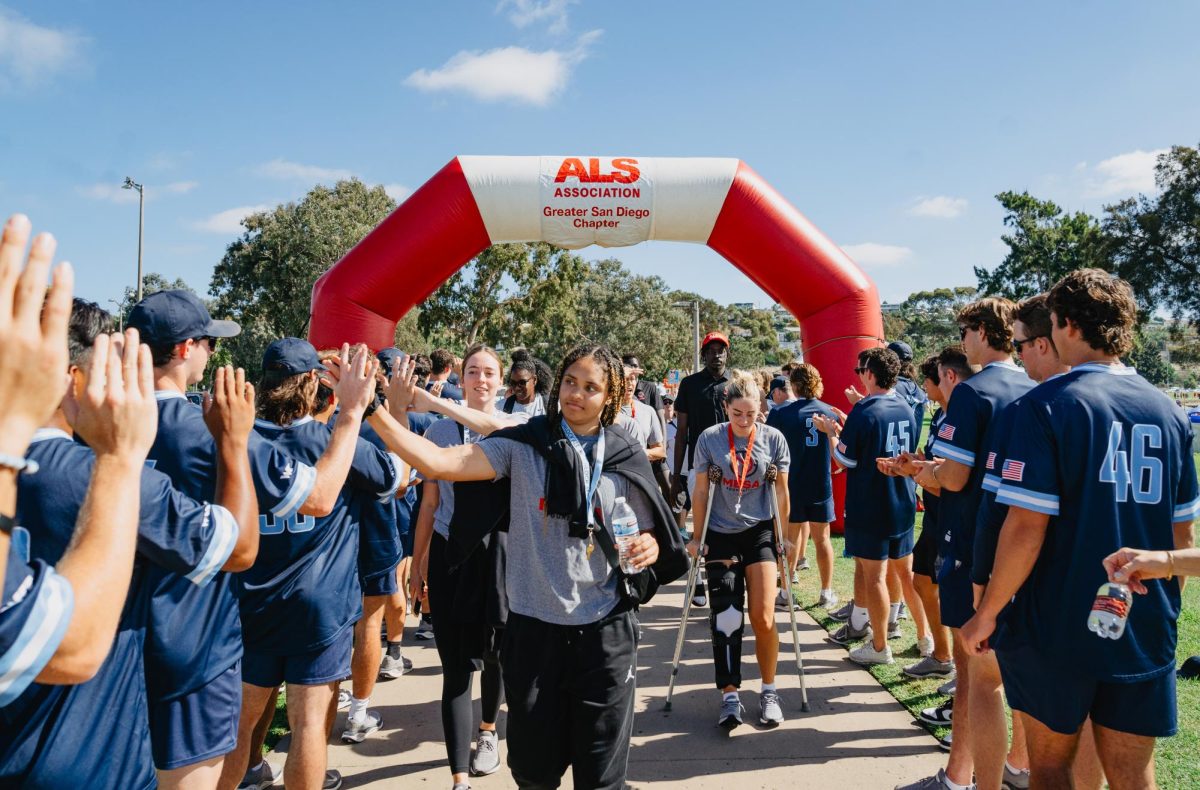USDs baseball team greets womens basketball player senior Jada Lewis, along with her fellow MESA Foundation team, as they walk the finish line at the ALS walk on Oct. 22, 2023.