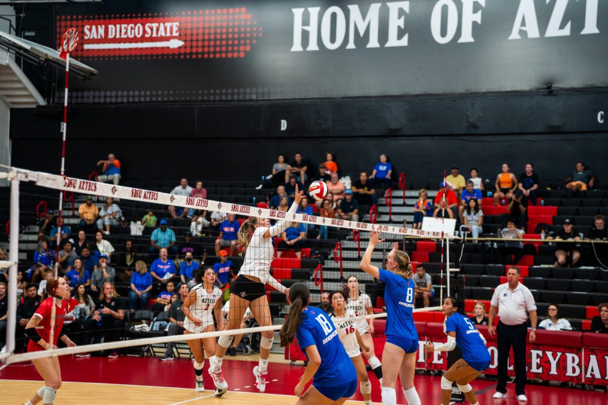 San Diego State middle block Amber Keen (4) tries a tip against Boise States Anabel Kotzakov (18) and Chey Day (8) on Thursday, Oct. 19 at Aztec Court at Peterson Gym. The Aztecs topped the Broncos 3-1.