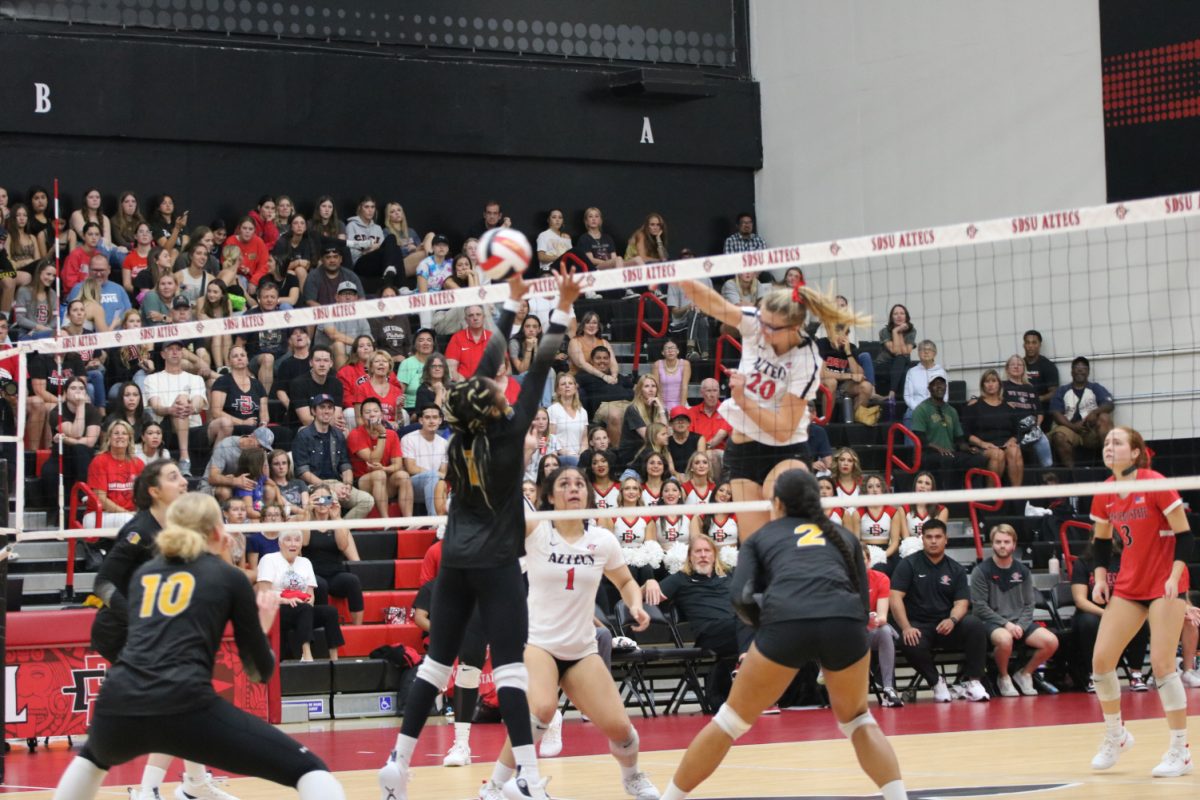San Diego State middle blocker Elly Schrader (20) attacks during a match earlier this season at Aztec Court at Peterson Gym. The Aztecs fell in four sets the Mountain West-leading Utah State on Saturday, Oct. 21.