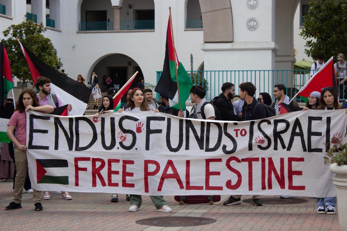 End U.S. Funds To Israel, Free Palestine reads the sign Students for Justice in Palestine SDSU held at the Student Union on Oct. 11.