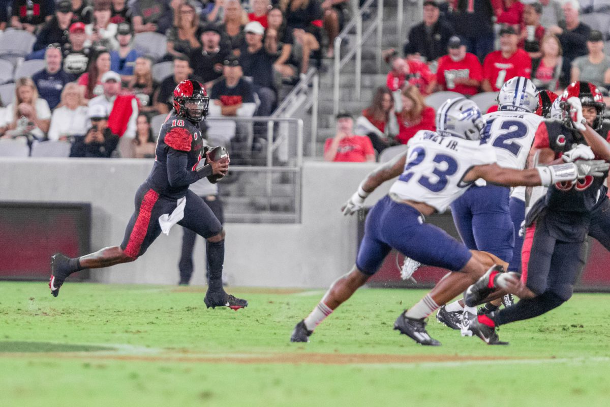 Aztec quarterback Jalen Mayden (18) looks downfield while running out of the pocket during a game against the Nevada Wolfpack on Oct. 21, 2023 at Snapdragon Stadium.