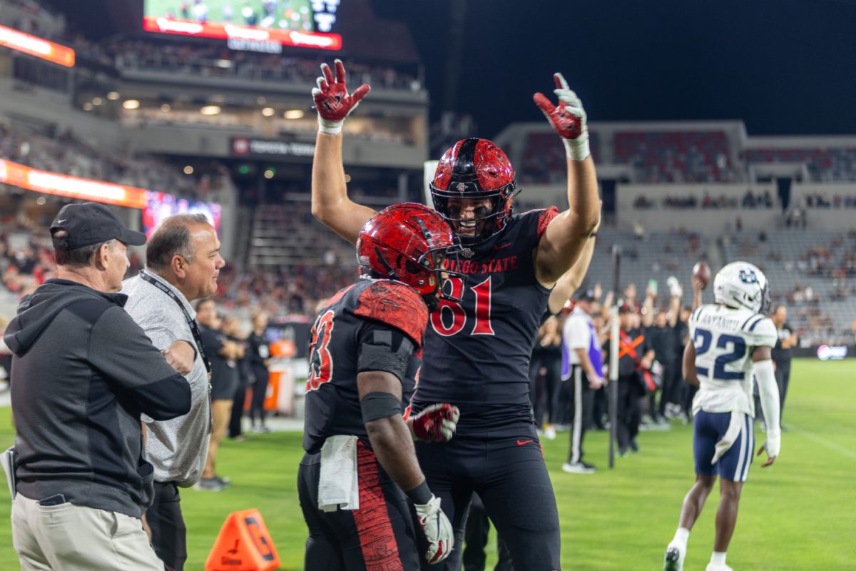 San Diego State tight end Mark Redman (81) celebrates with running back Kenan Christon (23) after a 10-yard touchdown catch in the fourth quarter. Christon finished the game with 117 yards of total offense.