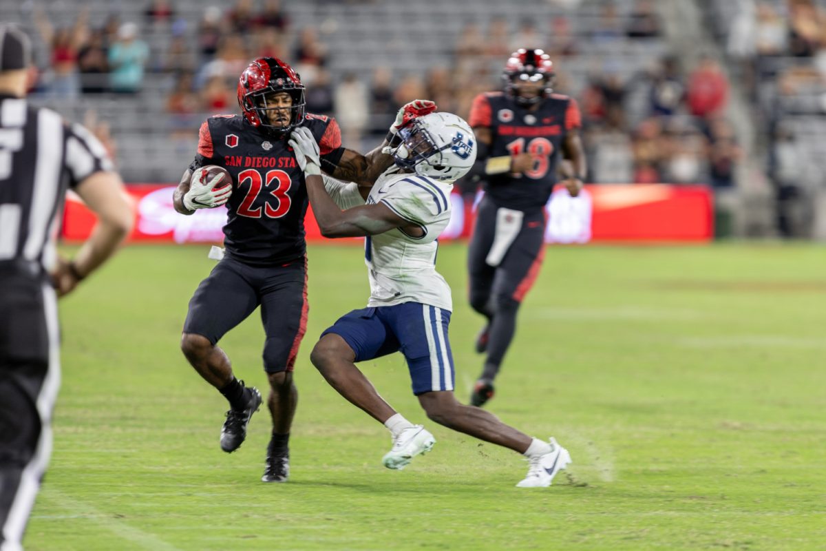 San Diego State running back Kenan Christon stiff-arms a Utah State defender during the Aztecs homecoming game on Saturday, Nov. 4 at Snapdragon Stadium. Utah State won 32-24 in double overtime.