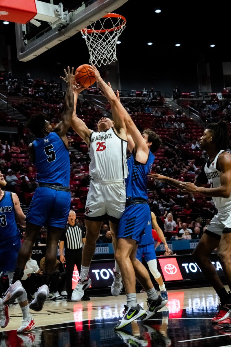 San Diego State forward Elijah Saunders battles in the paint against a pair of Cal State San Marcos defenders in an exhibition game on Monday, Oct. 30 at Viejas Arena.