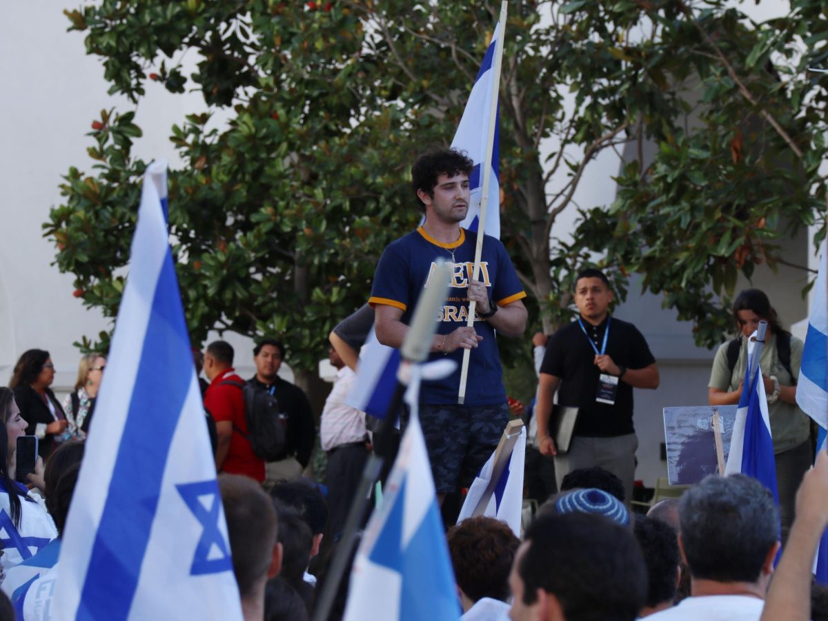 Alpha Epsilon Pi President and Hillel Ambassador Ori Lerer speaks in front of a crowd of demonstrators as they stand in solidarity with Israel on Oct. 9. This demonstration occurs after the Hamas attack on Israel on Oct. 7. 