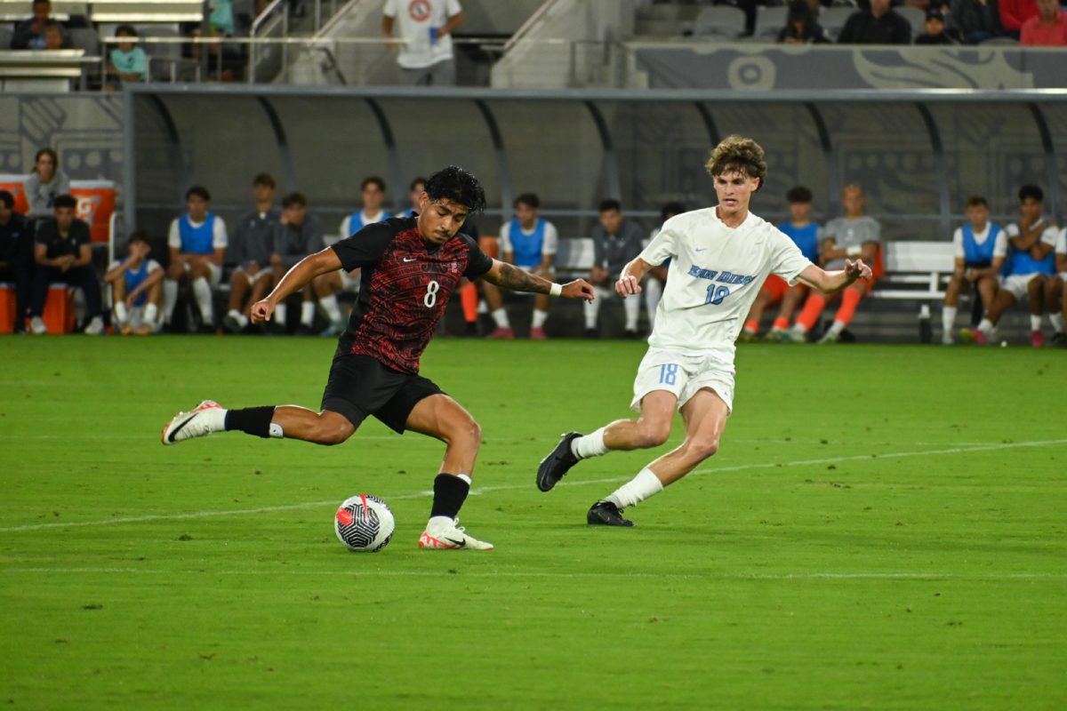 San Diego State midfielder Beto Apolinar prepares to play the ball while defended by University of San Diego forward Sammy Kanaan on Oct. 14 at Snapdragon Stadium. The Aztecs and Toreros played to a 1-1 draw.