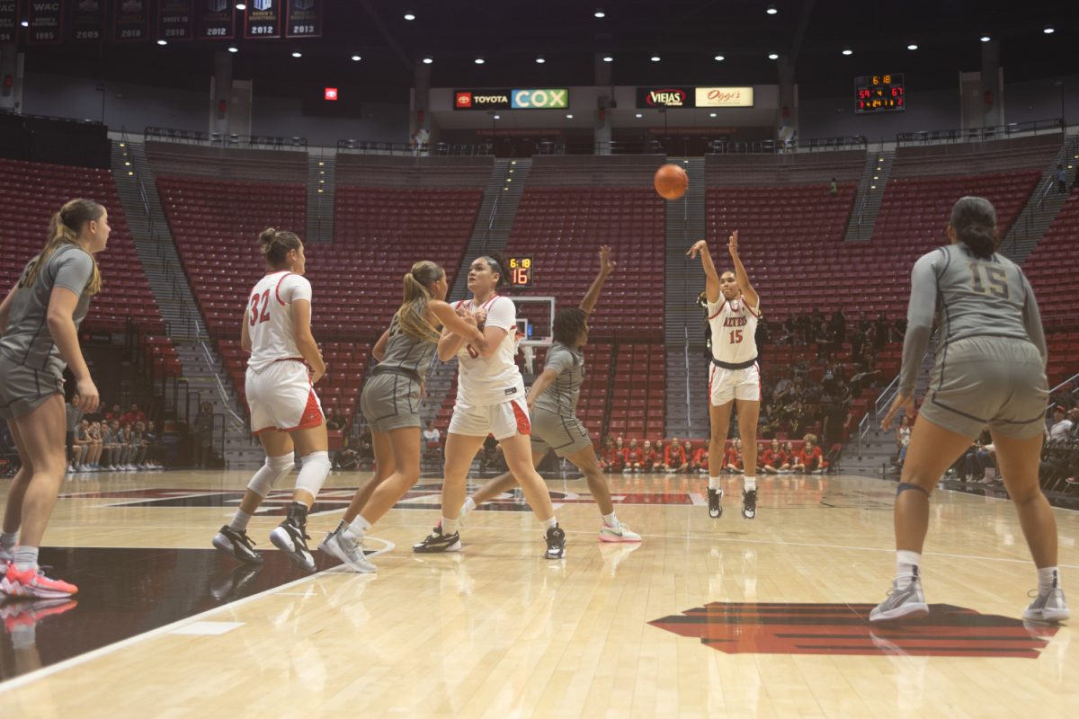 San Diego State guard Jada Lewis (15) takes a 3-pointer earlier this season at Viejas Arena. Lewis topped the 20-point mark for the third time in Scarlet in Black in the Aztecs 74-71 overtime win over Colorado State on Saturday, Dec. 30.