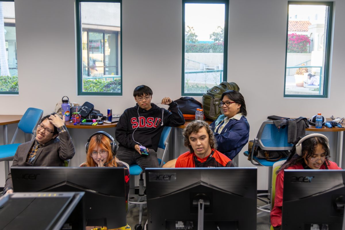 SDSUs Splatoon team - Carne Inksada Fries - (from left) Jason Cookie Tran, Lupita Kablamoshi Tello, Christopher Dashing Konz and Alondra StupidStrawberry Chula compete with the Imperial Valley College Diamond Rays in the Esports Engagement Center on Sunday, Dec. 3, with Lorenzo Seyer Mestido and Bernard BarnYard Bausa watching in the back. Carne Inksada Fries lost to the Diamond Rays 4-2. 