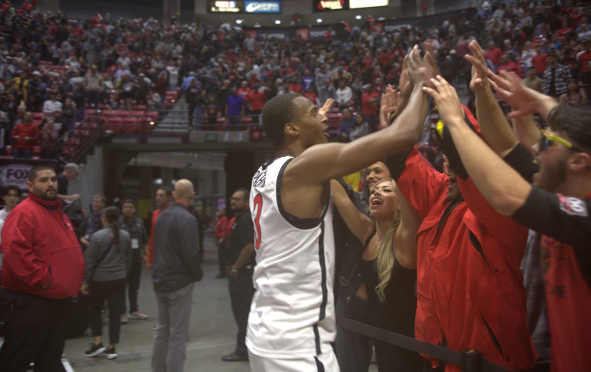 San Diego State guard Micah Parrish celebrates with fans after the Aztecs 63-62 win over UC Irvine on Saturday, Dec. 9 at Viejas Arena. Parrish made the game-winning shot with 10.4 seconds remaining and scored 14 points in the game.