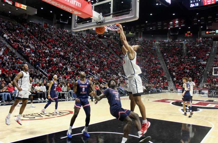 San Diego State Forward Jaedon LaDee drives over a pair of defenders for a slam dunk at Viejas Arena. LaDee scored 21 points, his eighth 20-point game for the Scarlet and Black, as the Aztecs won 74-47 vs. Fresno State on Wednesday, Jan. 3