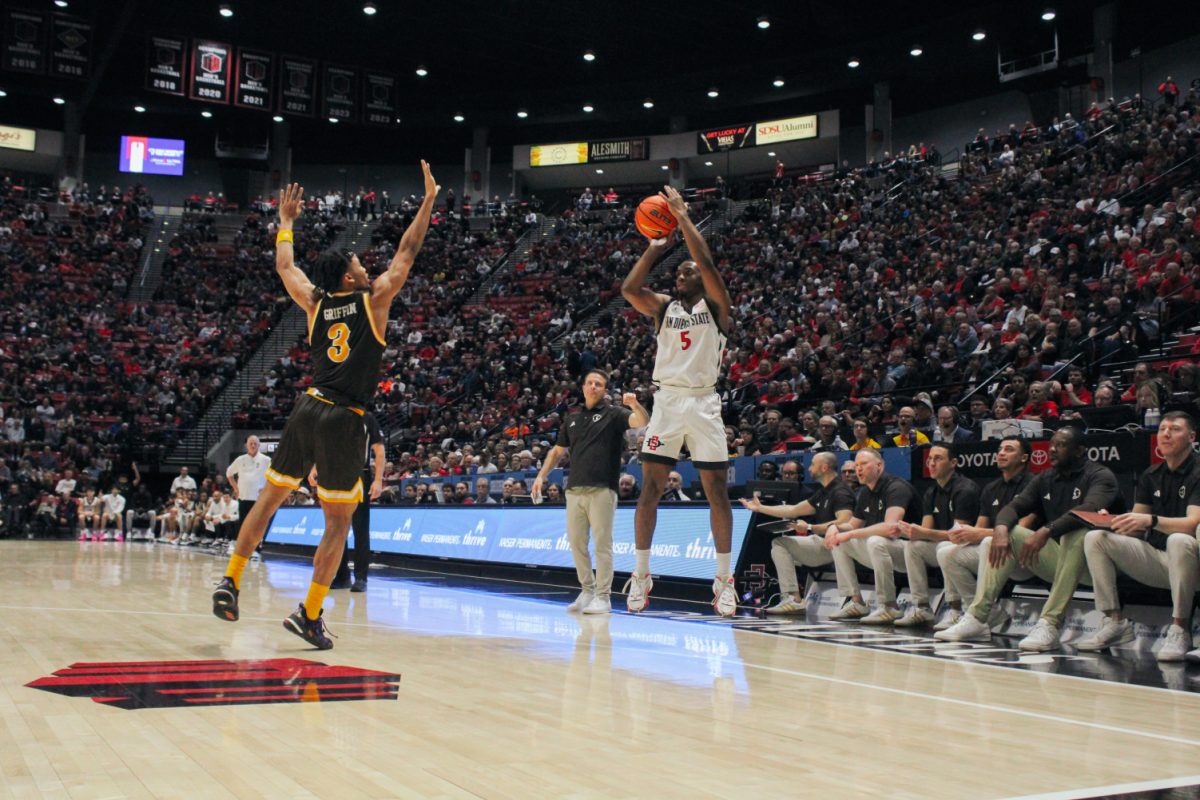 San Diego State guard Lamont Butler spots up for a jump shot over Wyoming guard Sam Griffin on Tuesday, Jan. 23 at Viejas Arena. Butler scored 23 points on 10 of 14 shooting, matching his previous career high, in the Aztecs 81-65 win over the Cowboys.