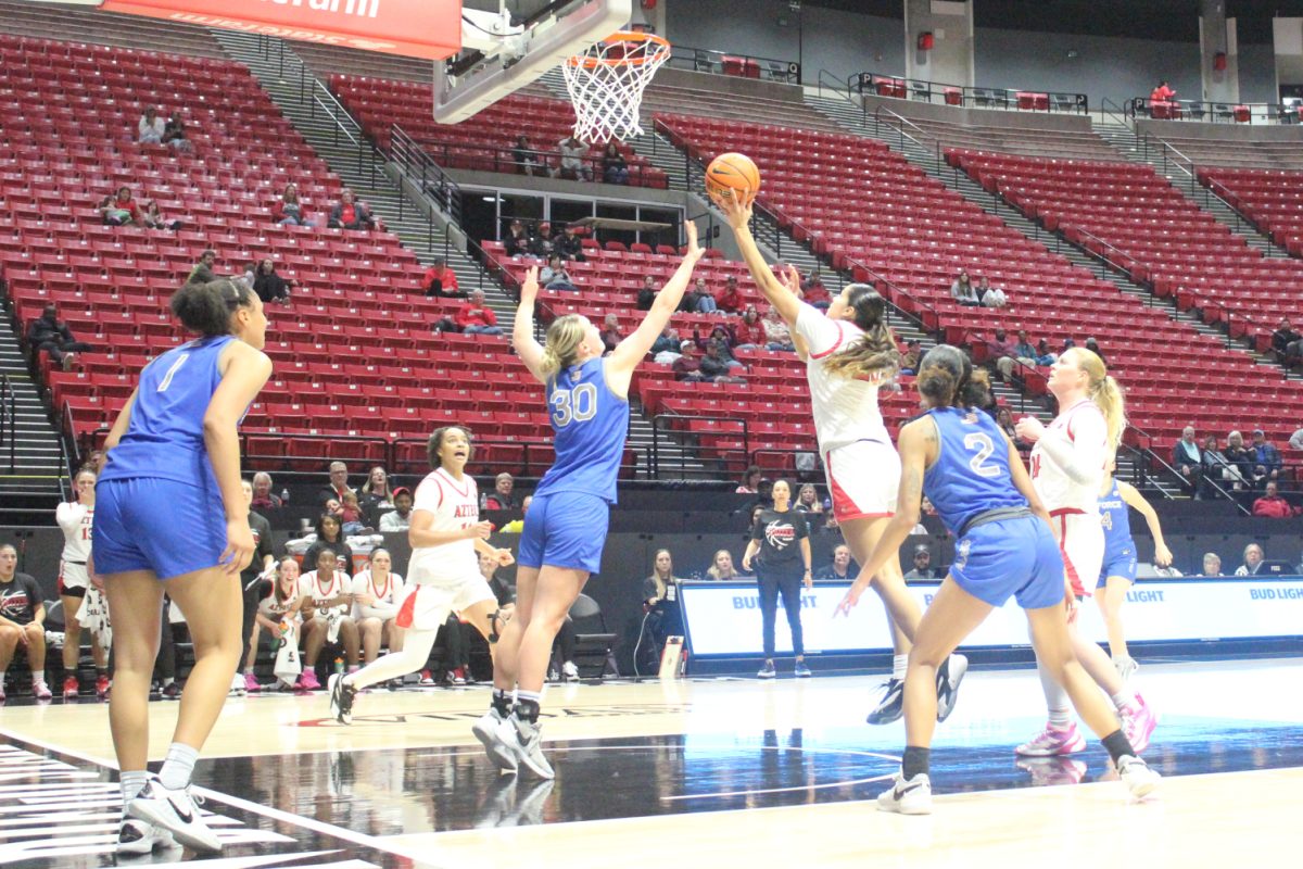 San Diego State forward Kim Villalobos rises for a shot over the defense of Air Force forward Dasha Macmillan on Wednesday, Feb. 22 at Viejas Arena. Villalobos recorded her sixth double-double of the season in the Aztecs 73-63 win over the Falcons.