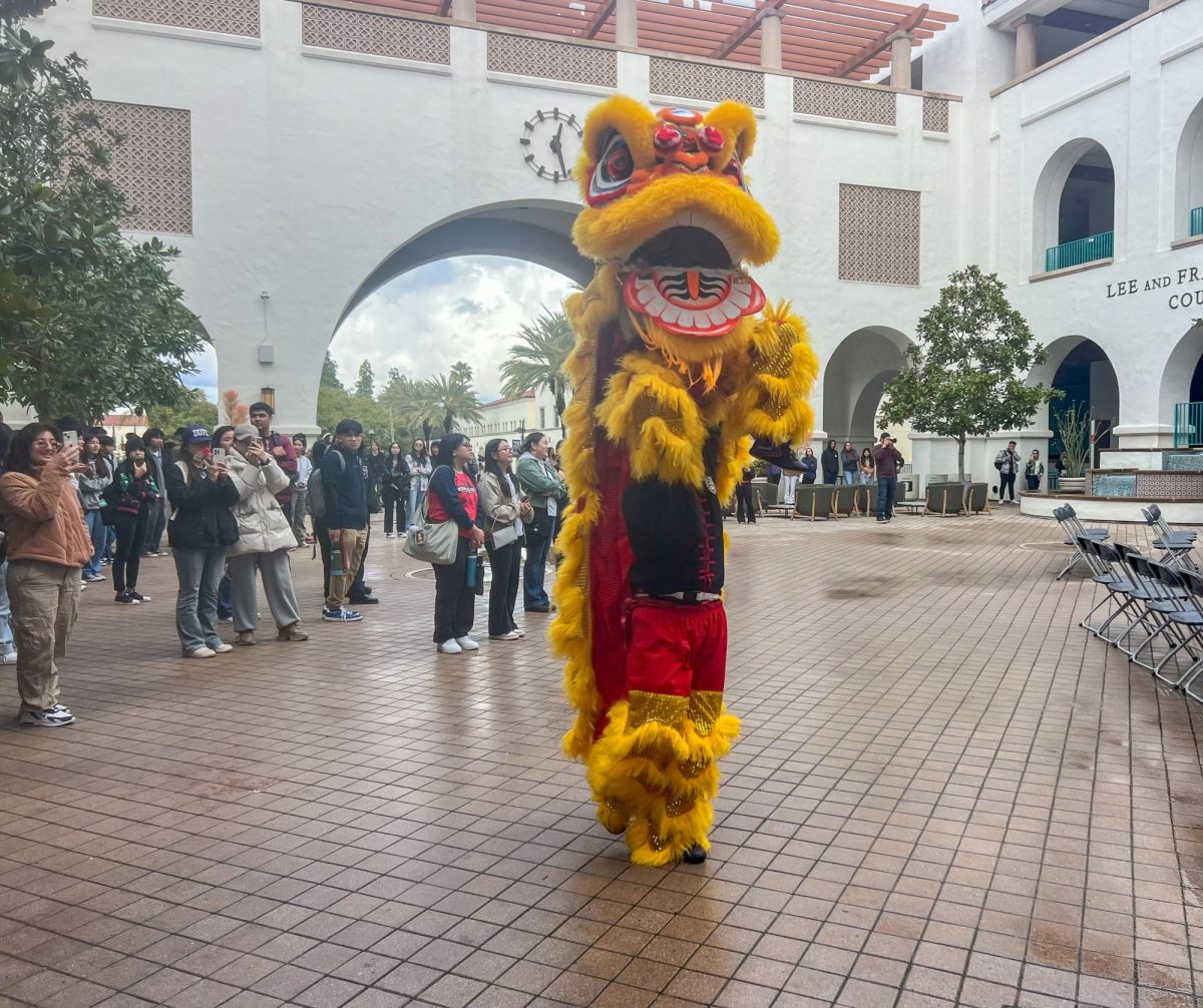 Students watch a dragon dance during the APIDA centers Lunar New Year celebration on Feb. 9