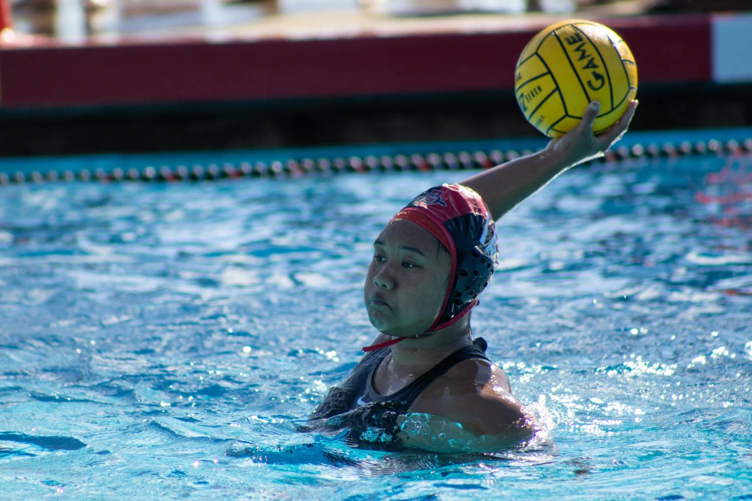 San Diego State goalkeeper Tiaare Ahovelo launches a ball back into the water earlier this season against Long Beach State on Saturday, Feb. 10. 