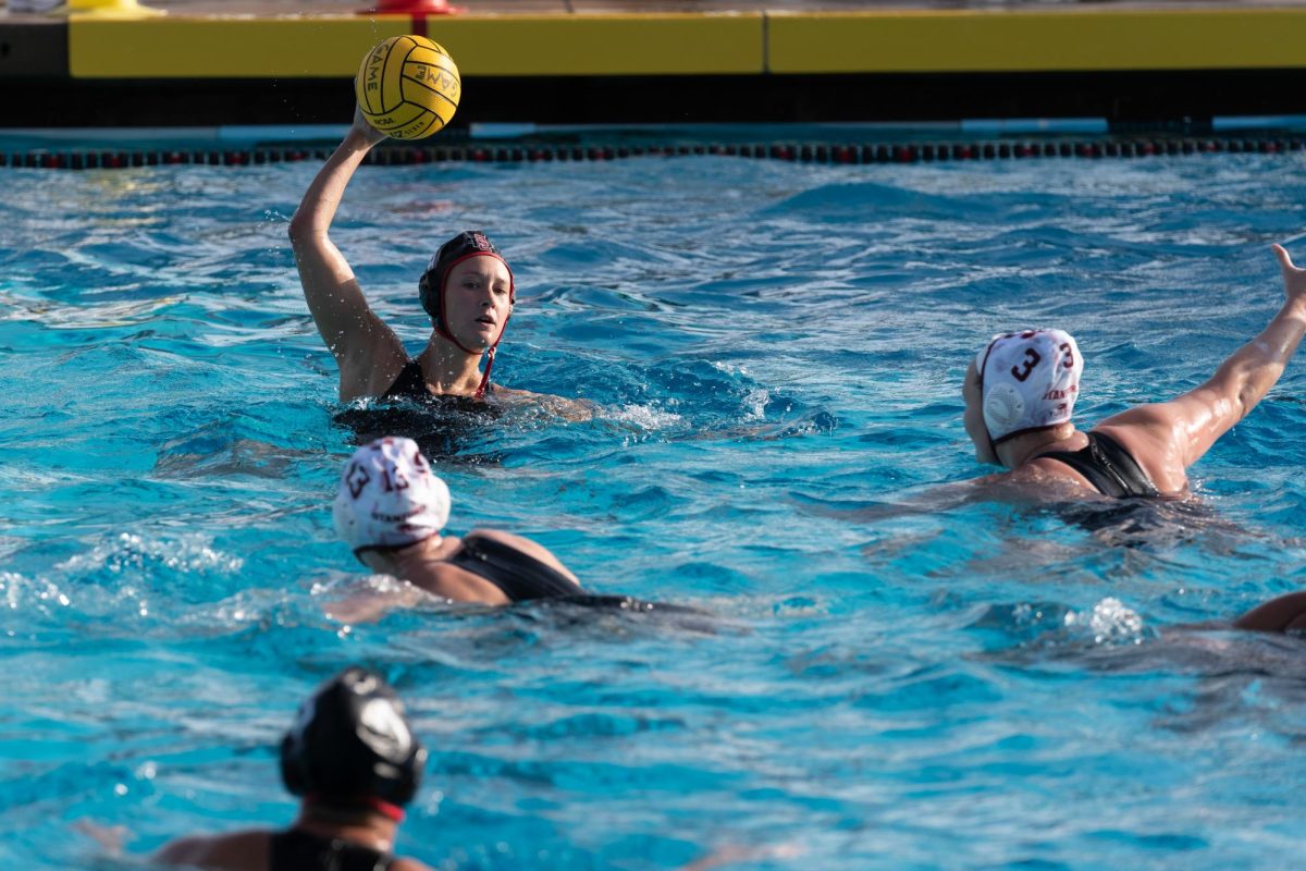 Attacker Kendall Houk eyes her teammate before she passes the ball against
Stanford on Saturday, Mar. 9 at Aztec Aquaplex. 