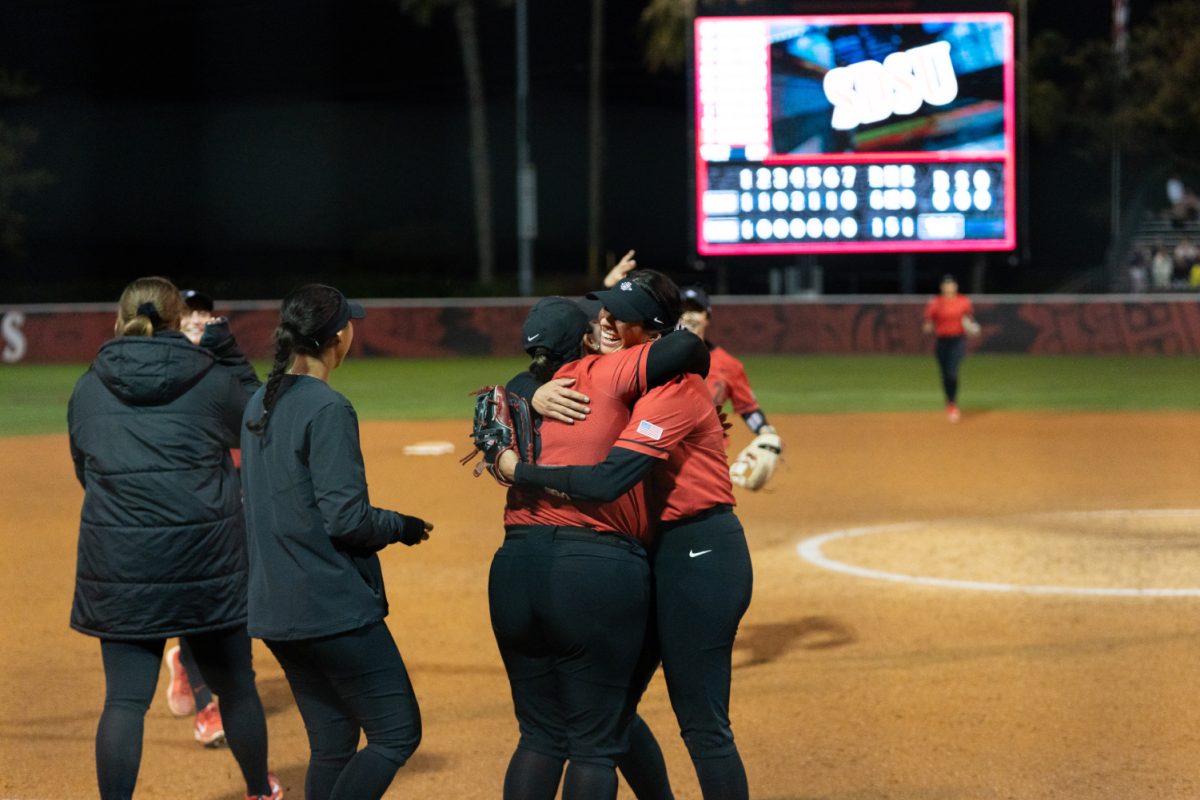 San Diego State pitcher Cassidy West hugs a teammate after a win earlier this season at SDSU Softball Stadium. West closed out the Aztecs 7-1 win over Long Beach State on Friday, March 8 at the Louisville Slugger Invitational in Long Beach.