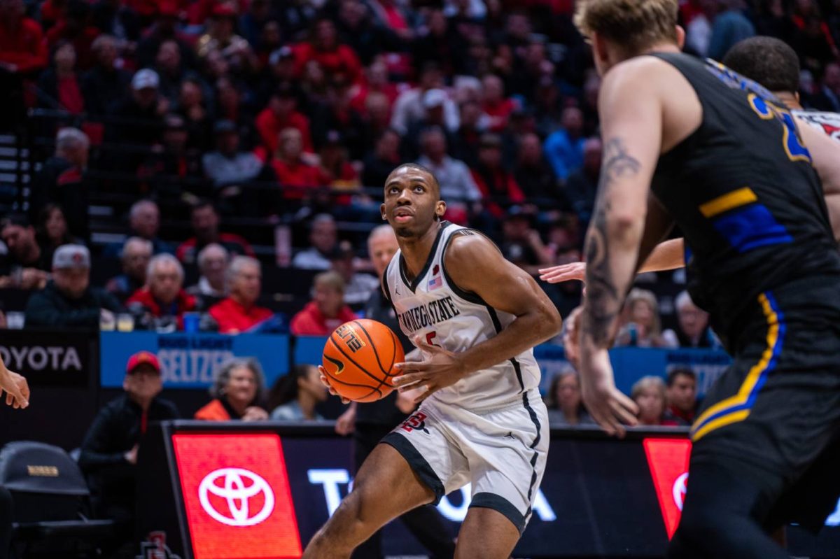 San Diego State guard Lamont Butler takes the ball in possession while guarded by several San Jose State defenders. earlier this season at Viejas Arena. Butler had 10 points in the crucial loss against UNLV 62-58 on Tuesday, Mar. 5. 