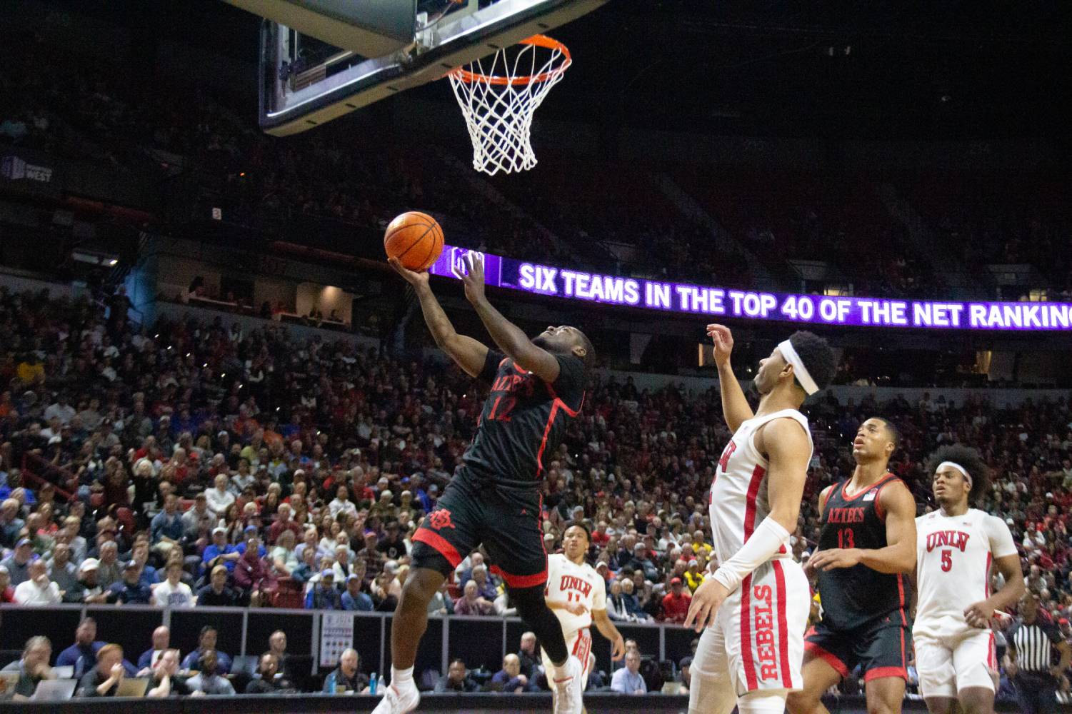 San Diego State guard Darrion Trammell lays up the ball in the paint over a pair of UNLV defenders earlier this season at Thomas & Mack Center. Trammell had 18 points in the second round win over Yale 85-57 on March 24. 