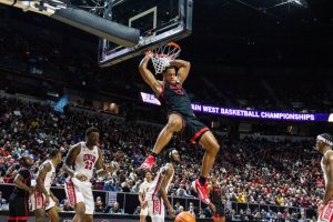 San Diego State forward Jaedon LeDee hangs onto the rim after a dunk over several UNLV defenders on Thursday, March 14 at the Thomas & Mack Center in Las Vegas. LaDees 34 points helped the Aztecs advance to the semifinals of the Mountain West Championships. 