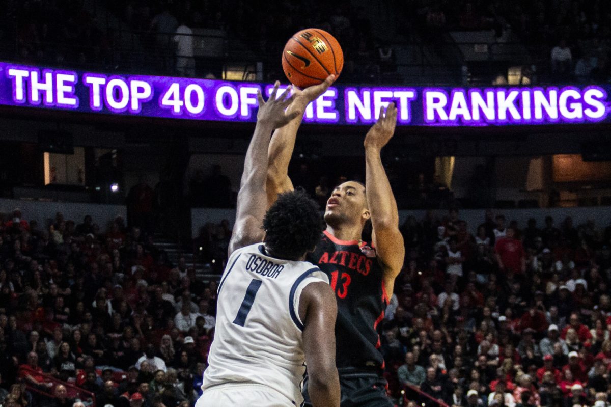 San Diego State forward Jaedon LeDee takes a shot over Utah State wing Great Osobor in the Semifinals of the 2024 Mountain West Championships in Las Vegas. LeDee was named as an AP third team All American, joining Michael Cage, Kawhi Leonard and Malachi Flynn as the only AP All Americans in SDSU mens basketball program history.