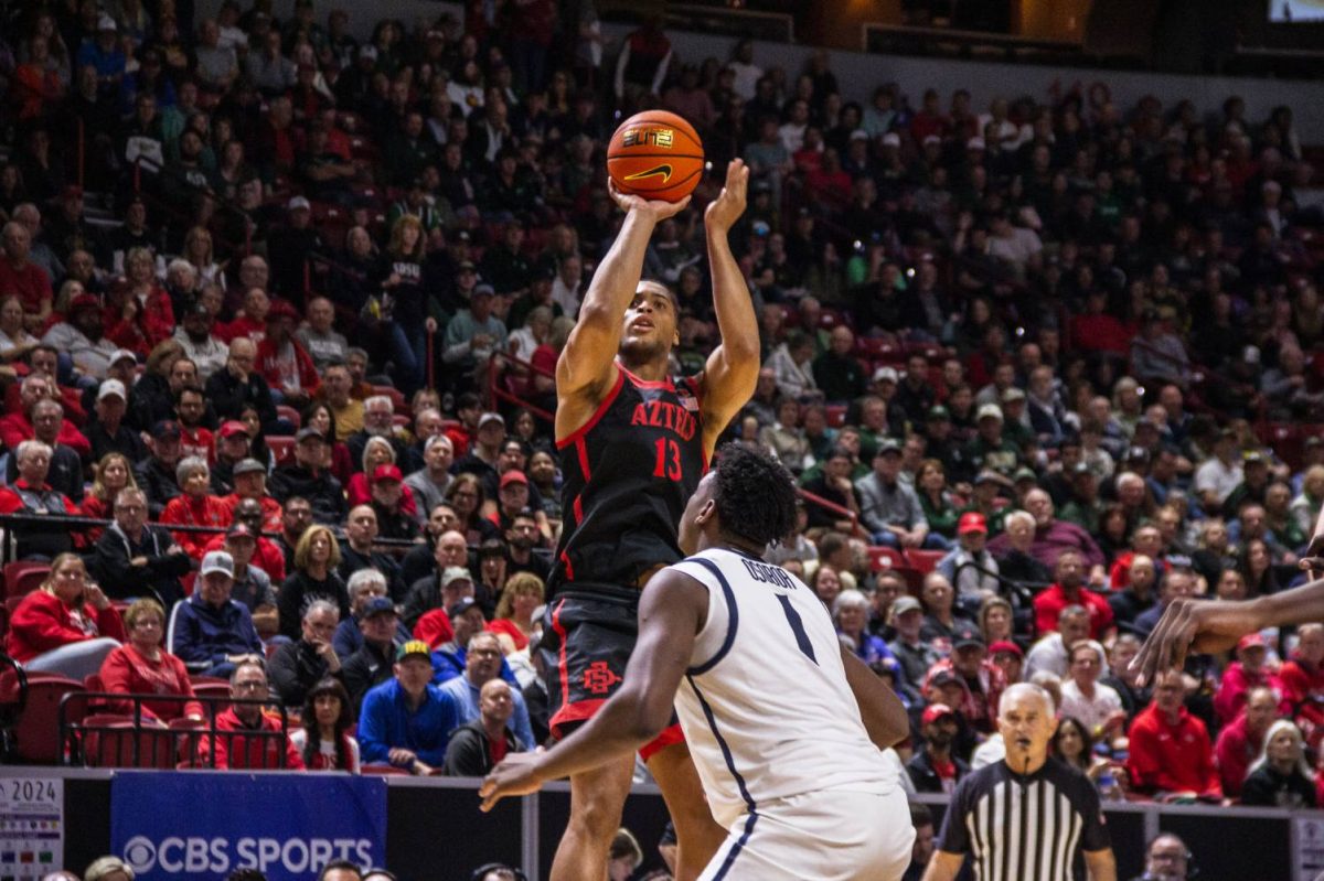 San Diego State forward Jaedon LeDee makes a jump shot over Utah State forward Great Osobor. LeDee scored 22 points in the 86-70 win over the Aggies on Friday night. 