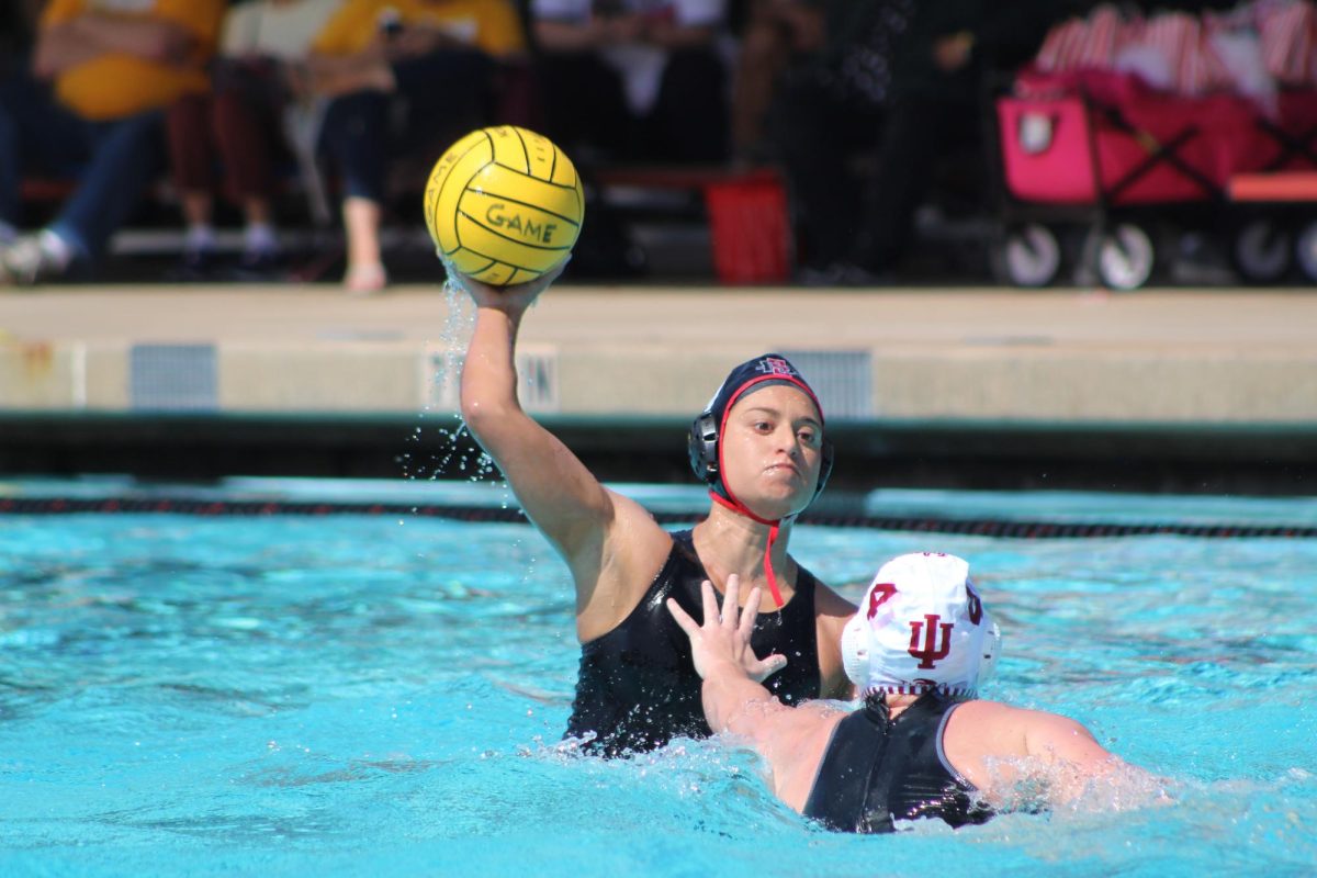 Sophomore Hannah Bell (#9) prepares to make a pass to her teammate during a match vs. insert here on Saturday, March 9 at the Aztec Aquaplex.