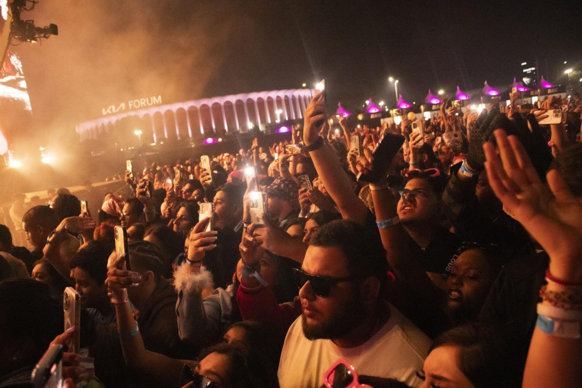 Fans take out their phones to capture moments of their favorite artists performing on stage at Rolling Loud