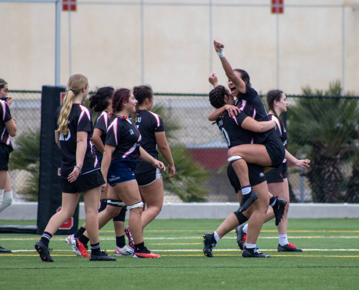 The San Diego State womens rugby team celebrates after scoring against the University of Arizona on Feb. 17. 
