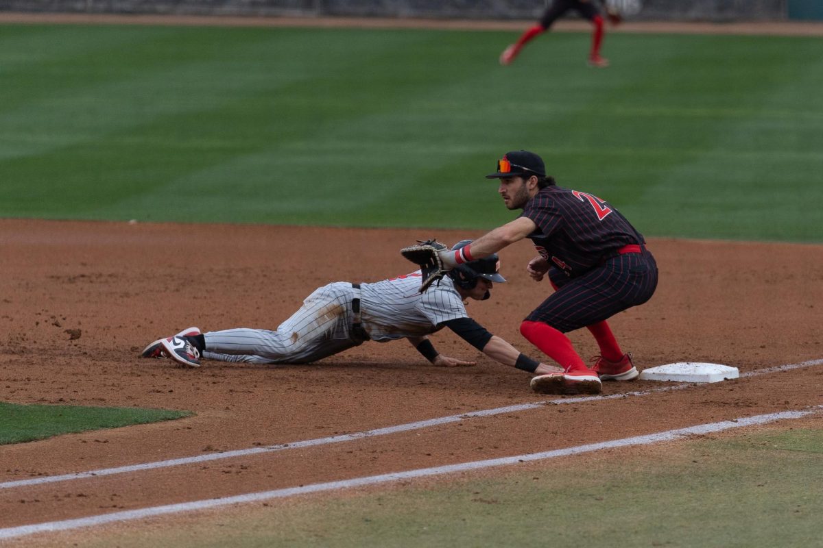Infielder Brady Lavoie looks to pick off a UNLV player on first base during the series opener.