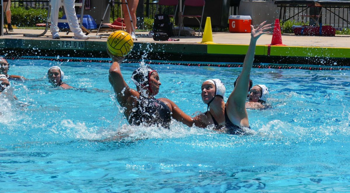 Center Danni Croteau attempts to make a pass against a UC San Diego defender at the Aztec Aquaplex. The Aztecs celebrated Croteau on Senior Day despite the 12-9 loss to the Tritons in the Harper Cup match on Sunday, April 21. 